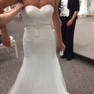 Strapless mermaid tulle wedding dress with crystal belt that can be sewed on.